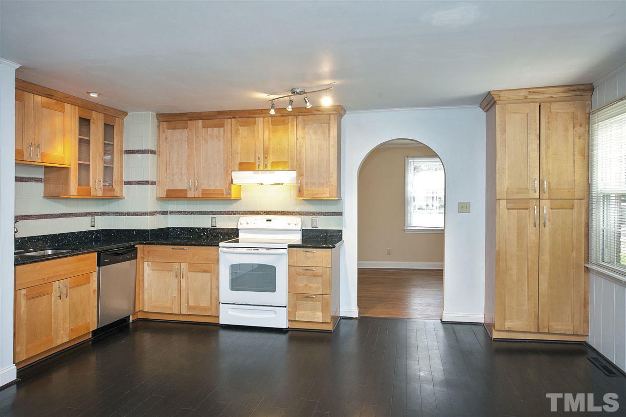 636 Brighton Road Raleigh, NC 27610 - Photo 8 of 25 a kitchen with stainless steel appliances granite countertop a stove a sink and a refrigerator