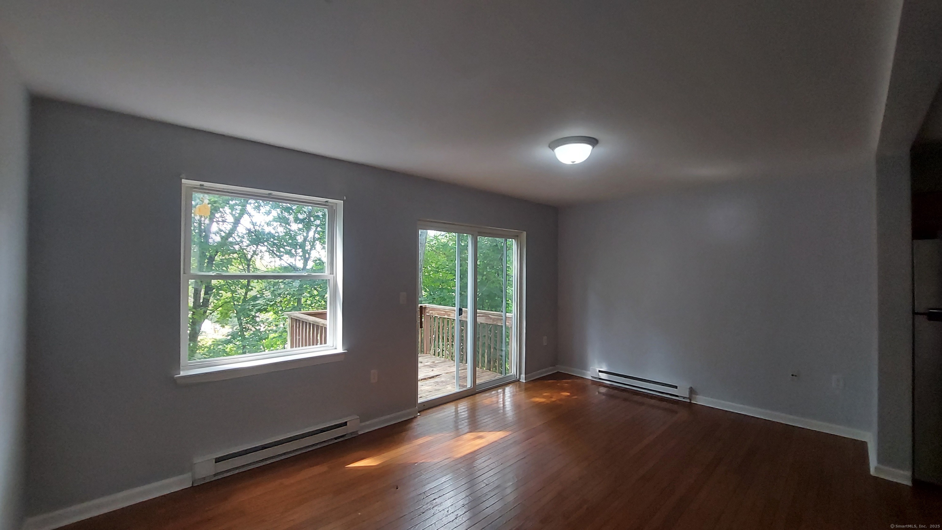 10 Hillcrest Street, Unit B Norwich, CT 06360 - Photo 12 of 34 an empty room with wooden floor and windows
