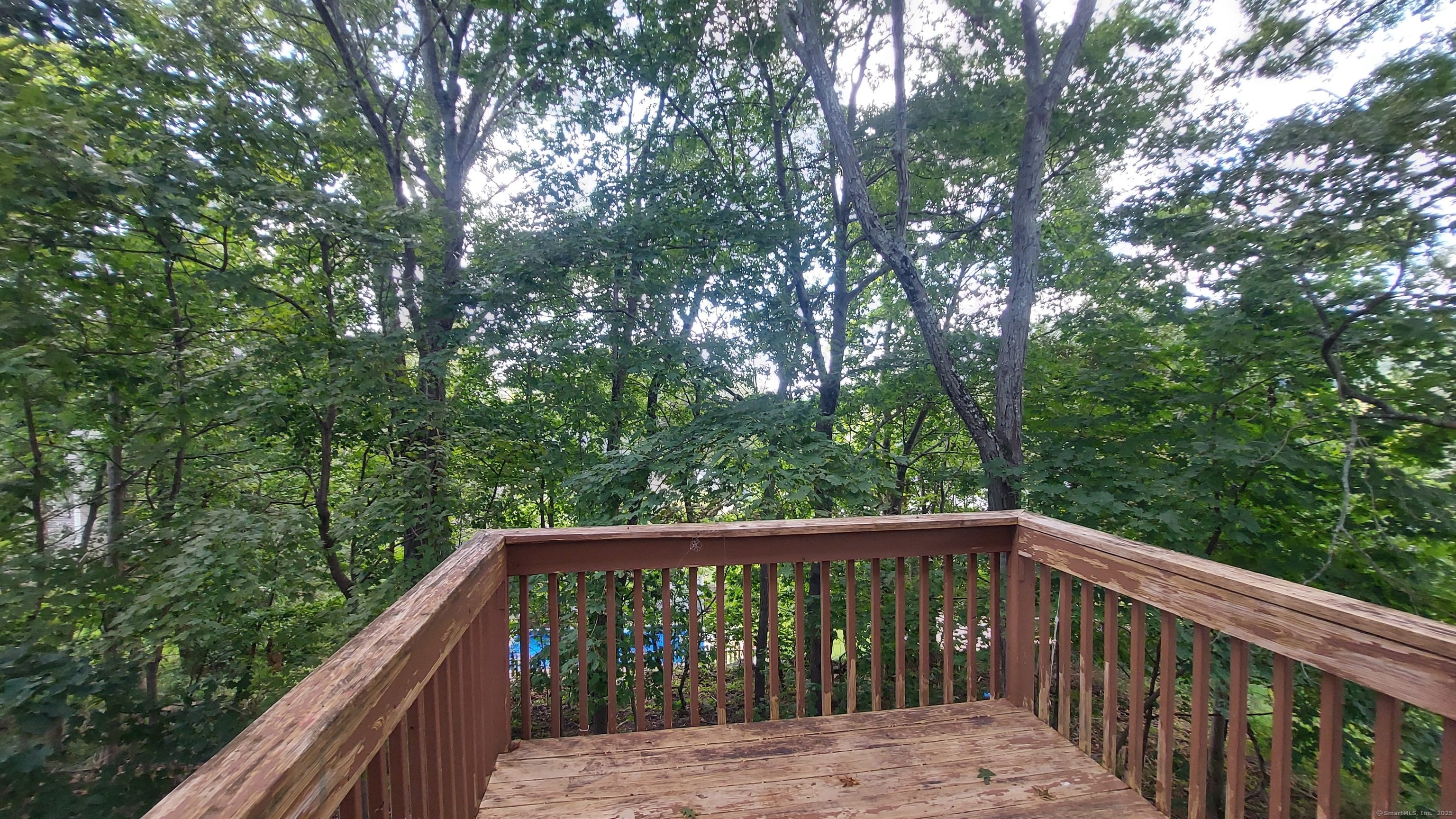 10 Hillcrest Street, Unit B Norwich, CT 06360 - Photo 17 of 34 a balcony with wooden floor and trees