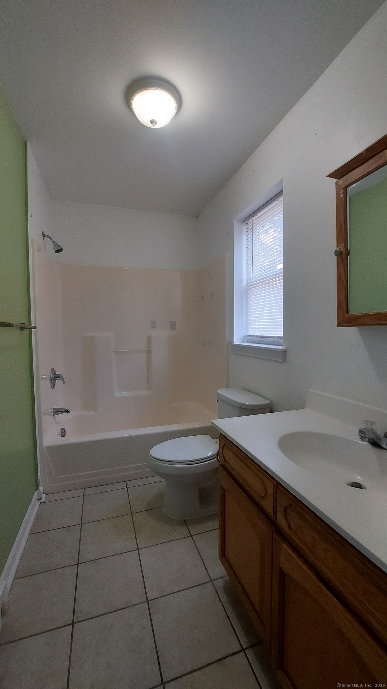 10 Hillcrest Street, Unit B Norwich, CT 06360 - Photo 19 of 34 a bathroom with a sink a toilet and a mirror