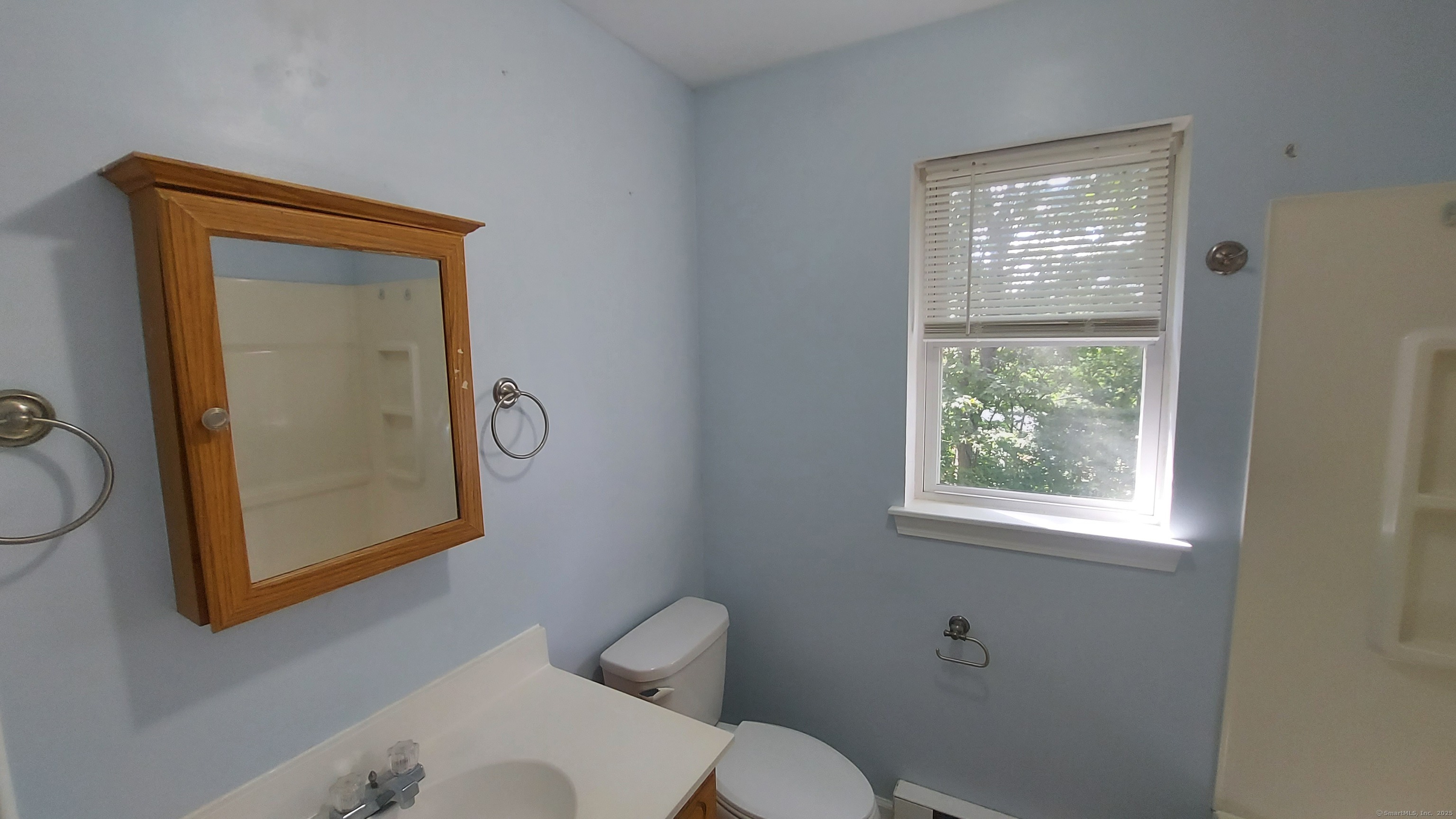 10 Hillcrest Street, Unit B Norwich, CT 06360 - Photo 22 of 34 a bathroom with a toilet sink vanity and mirror