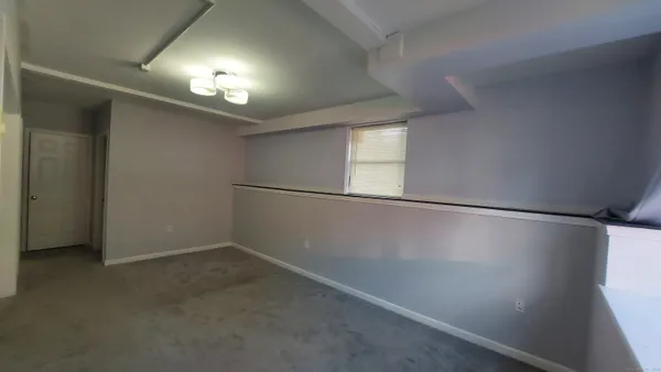 an empty room with windows and entrance