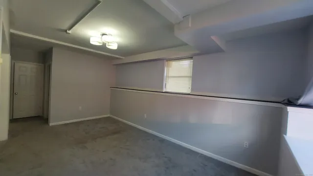 an empty room with windows and entrance