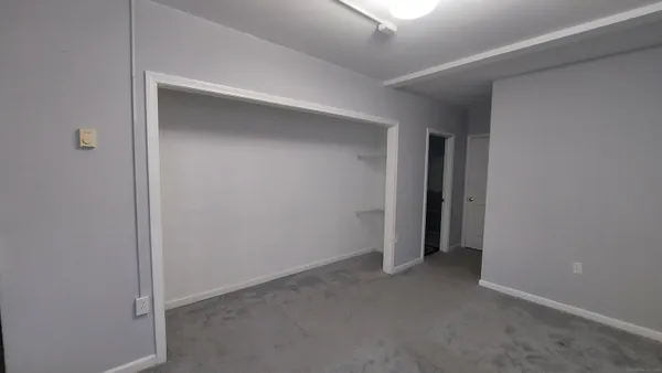 an empty room with a empty space and windows