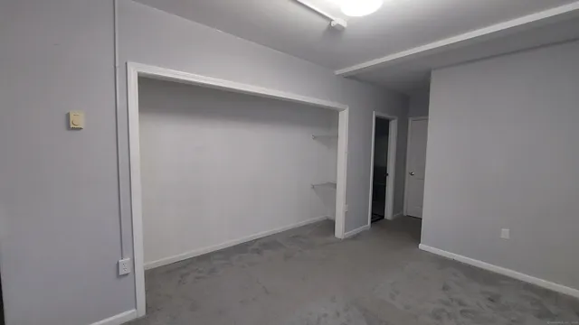 an empty room with a empty space and windows