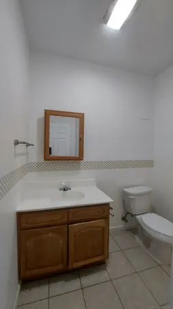 a white toilet sitting next to a bath tub