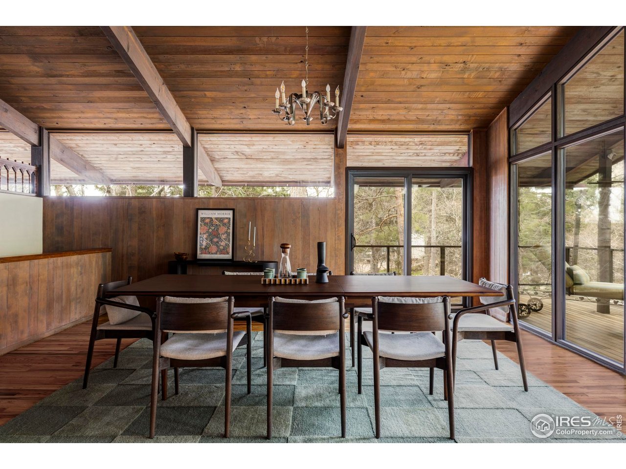 705 Willowbrook Road Boulder, CO 80302 - Photo 13 of 34 The adjoining dining room is wrapped in glass, with views of lush greenery all around.
