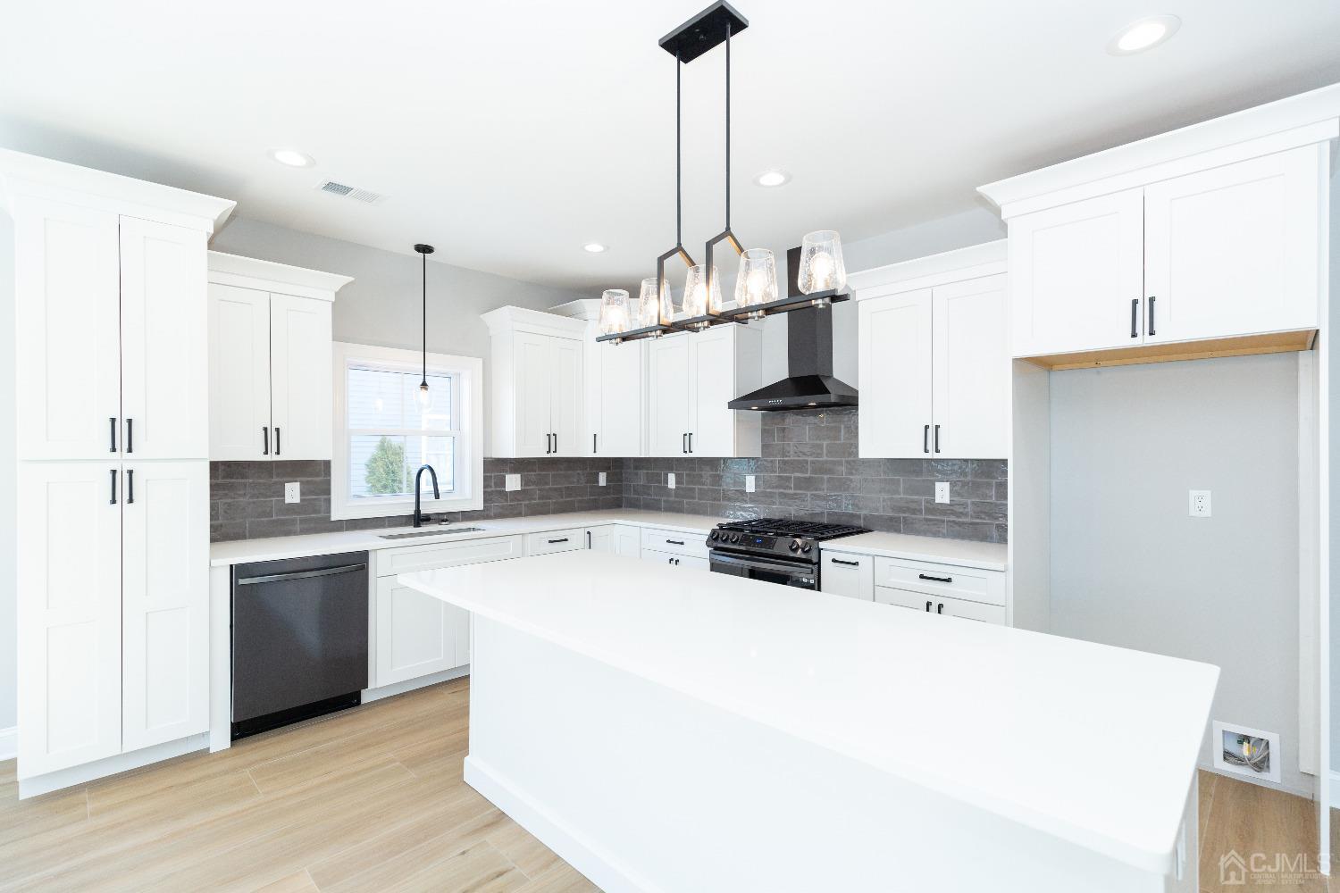 60 Brookville Road Edison, NJ 08817 - Photo 15 of 56 a kitchen with stainless steel appliances a stove a sink a refrigerator a center island and chairs