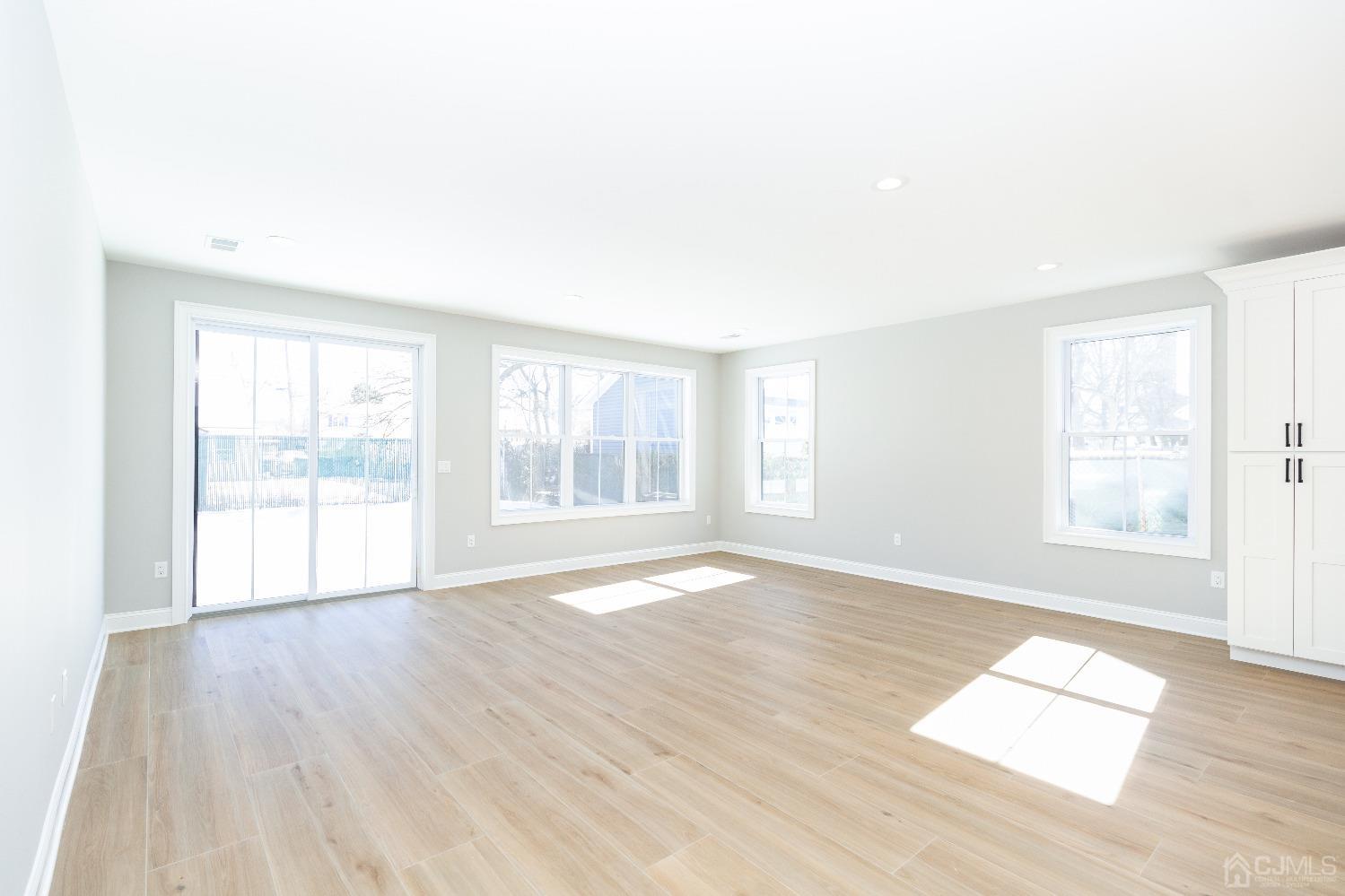 60 Brookville Road Edison, NJ 08817 - Photo 16 of 56 an empty room with wooden floor and windows