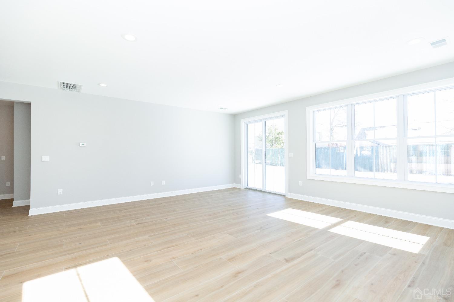 60 Brookville Road Edison, NJ 08817 - Photo 19 of 56 a view of an empty room with wooden floor and a window