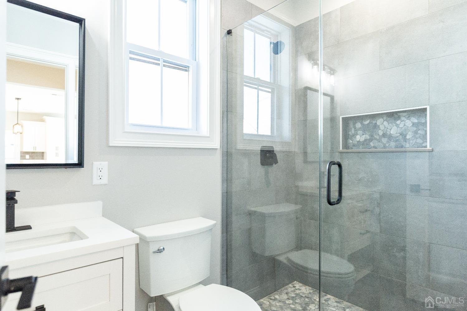 60 Brookville Road Edison, NJ 08817 - Photo 25 of 56 a bathroom with a toilet sink vanity and windows