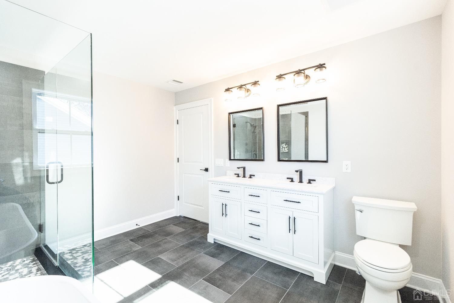 60 Brookville Road Edison, NJ 08817 - Photo 34 of 56 a bathroom with a toilet sink and mirror