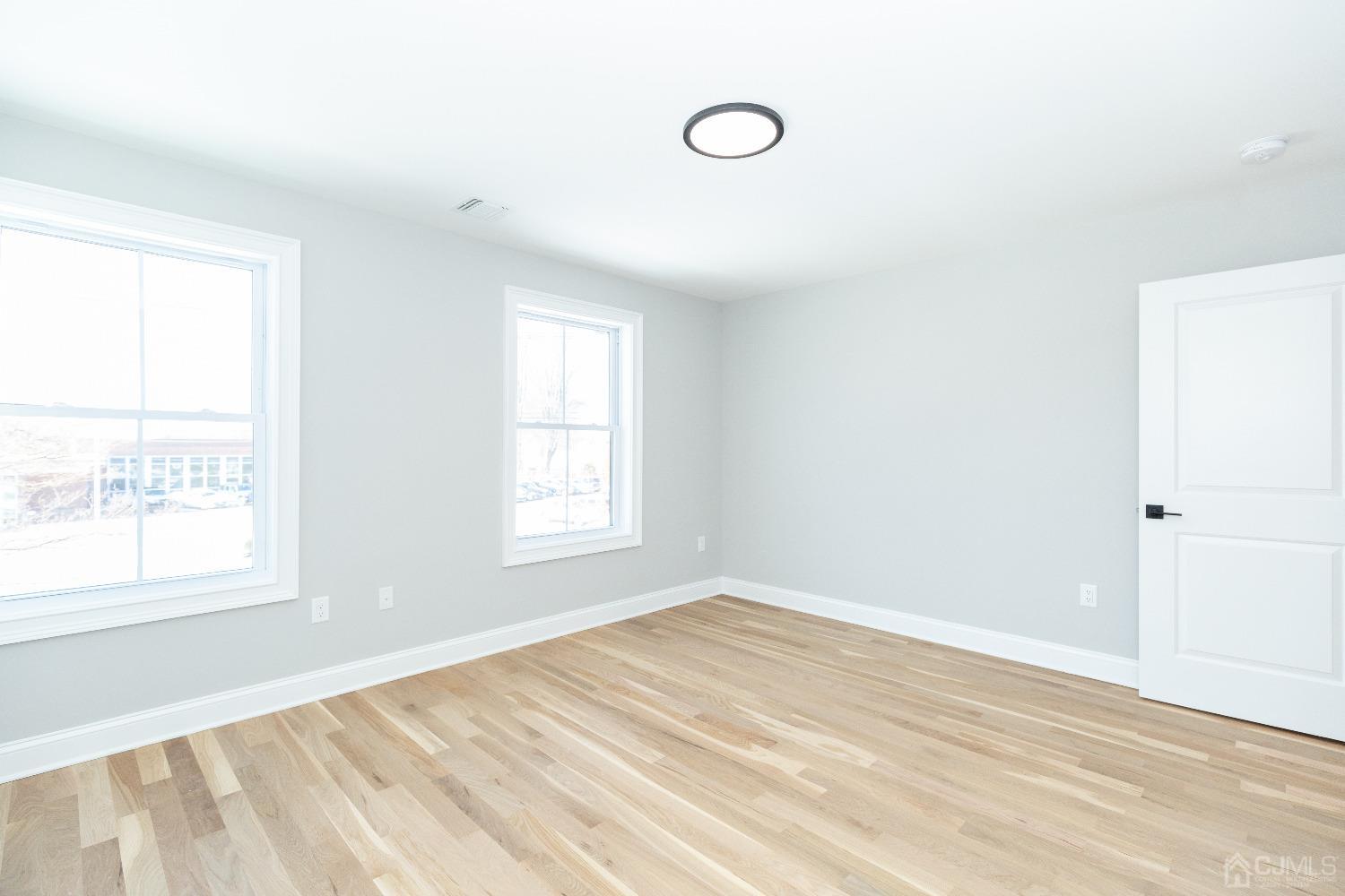 60 Brookville Road Edison, NJ 08817 - Photo 36 of 56 a view of an empty room with wooden floor and a window