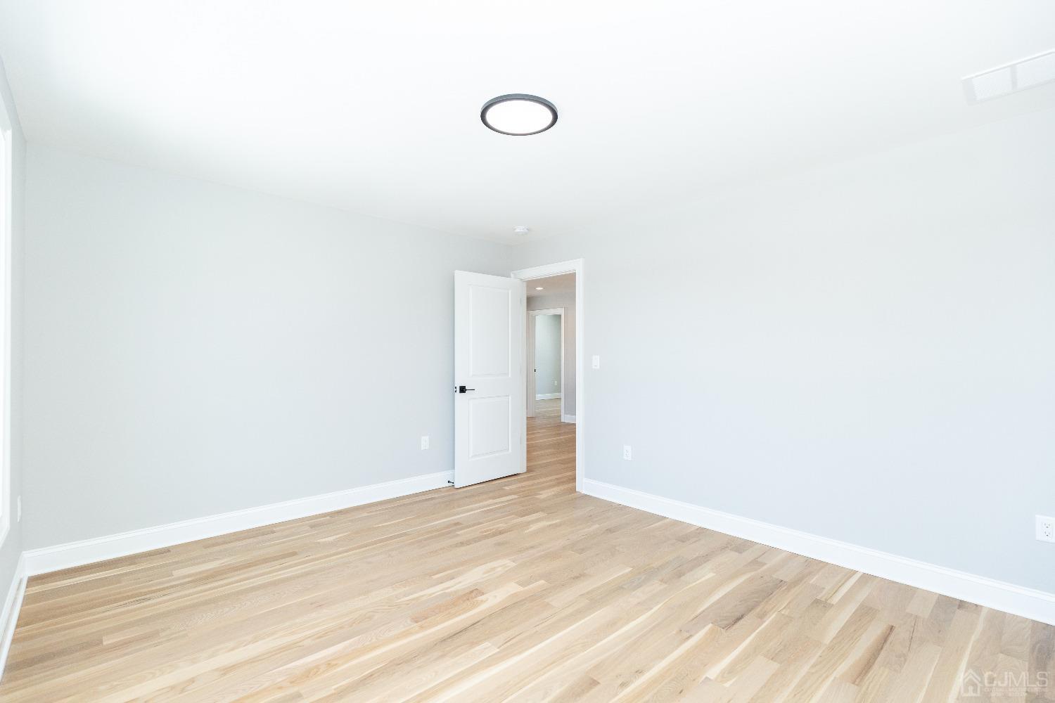 60 Brookville Road Edison, NJ 08817 - Photo 37 of 56 a view of a room with wooden floor and white walls