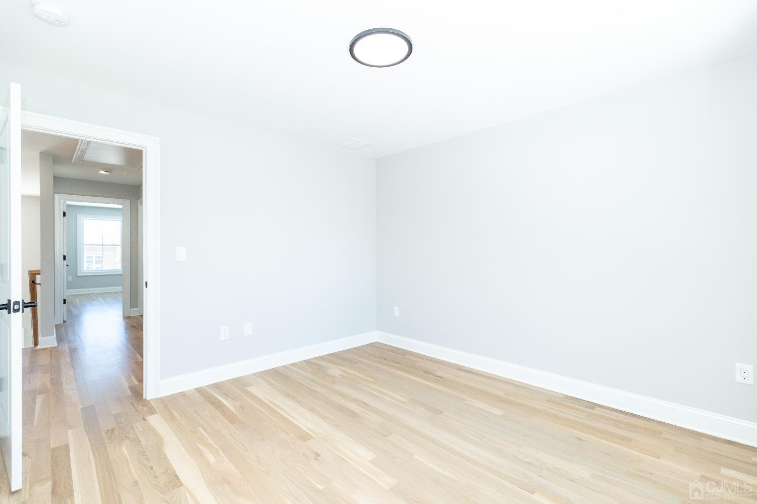 60 Brookville Road Edison, NJ 08817 - Photo 42 of 56 a view of a room with wooden floor and mirror