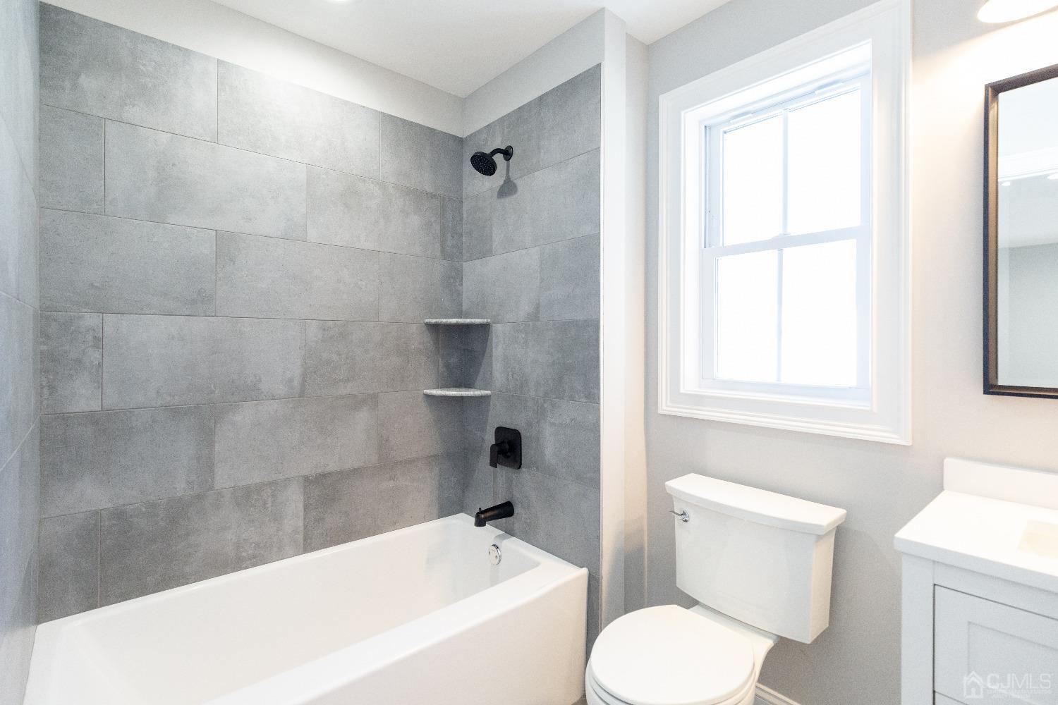 60 Brookville Road Edison, NJ 08817 - Photo 47 of 56 a bathroom with a toilet and a bathtub