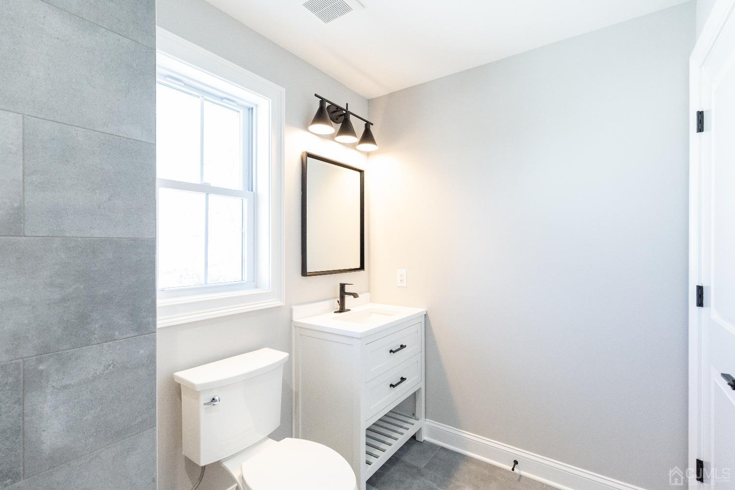 60 Brookville Road Edison, NJ 08817 - Photo 48 of 56 a bathroom with a toilet sink and mirror