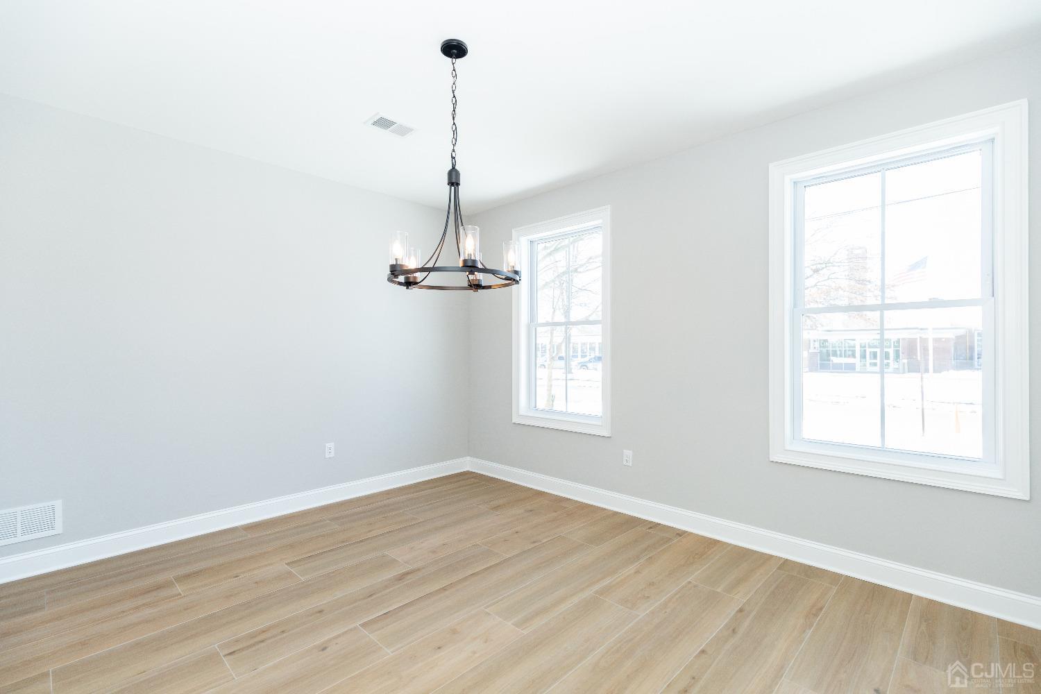 60 Brookville Road Edison, NJ 08817 - Photo 8 of 56 a view of empty room with a window and wooden floor