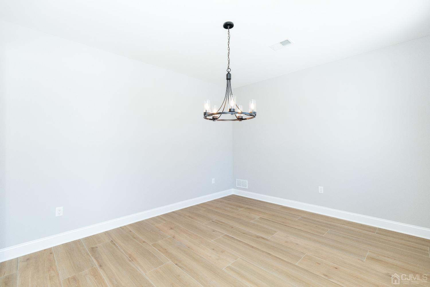 60 Brookville Road Edison, NJ 08817 - Photo 9 of 56 a view of a room with a wooden floor and a ceiling fan