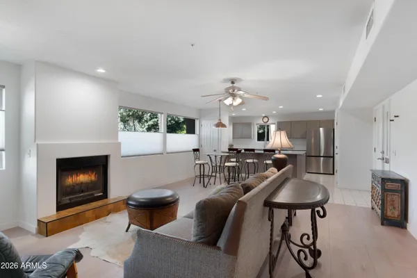 a living room with furniture a flat screen tv and a fireplace