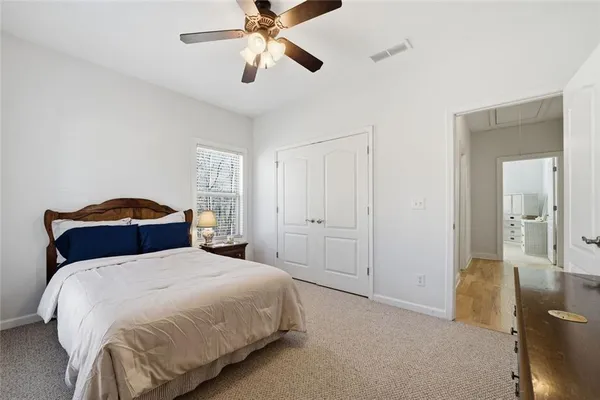 a bedroom with a large bed and a chandelier