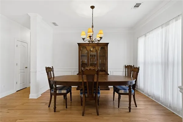 a view of a dining room with furniture window and wooden floor