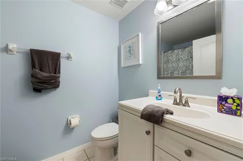 a bathroom with a sink toilet and vanity