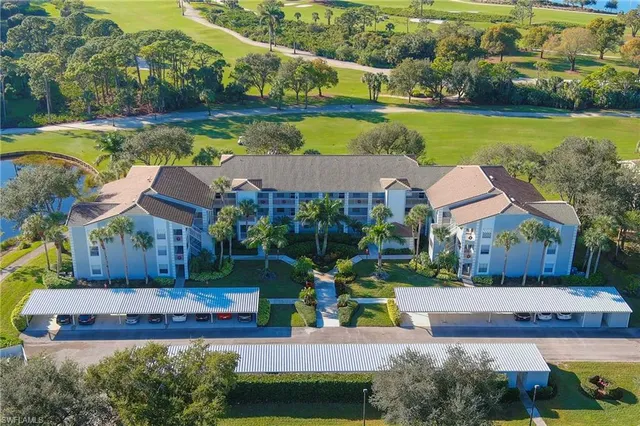 an aerial view of a house with a garden and lake view
