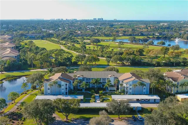 an aerial view of residential houses with outdoor space and swimming pool