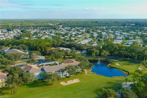 an aerial view of a house with a lake view