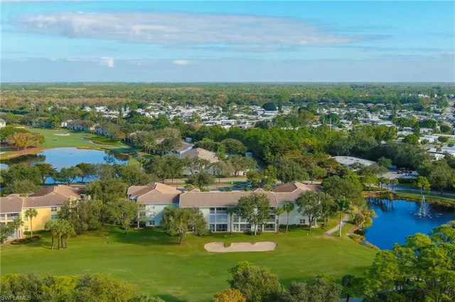 an aerial view of residential houses with outdoor space and lake view
