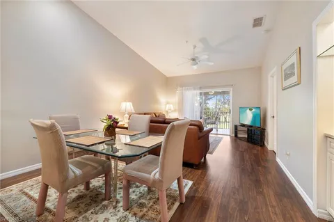 a view of a a dining room with furniture window and wooden floor