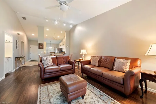 a living room with furniture and a ceiling fan