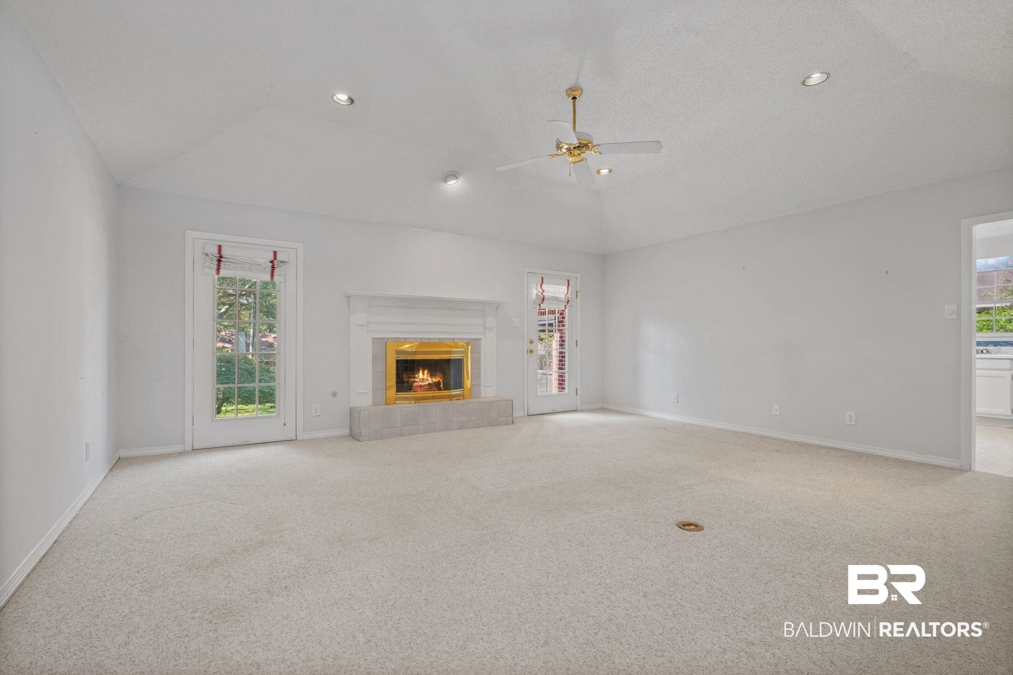 1340 Wellsley Court Mobile, AL 36695 - Photo 15 of 37 Unfurnished living room featuring light carpet, a tile fireplace, healthy amount of natural light, recessed lighting, and a ceiling fan