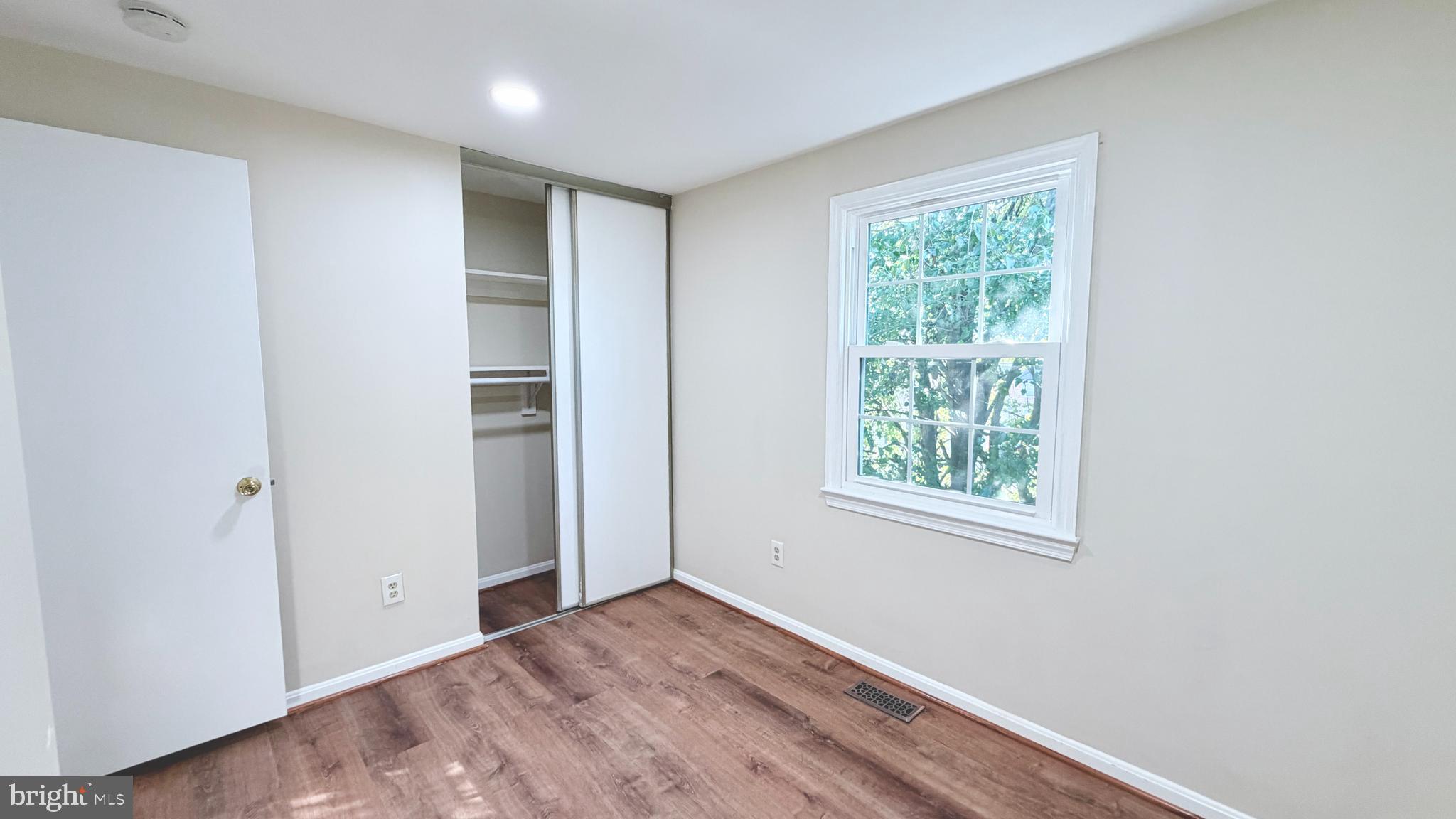 122 Sharpstead Lane Gaithersburg, MD 20878 - Photo 14 of 43 a view of an empty room with wooden floor and a window