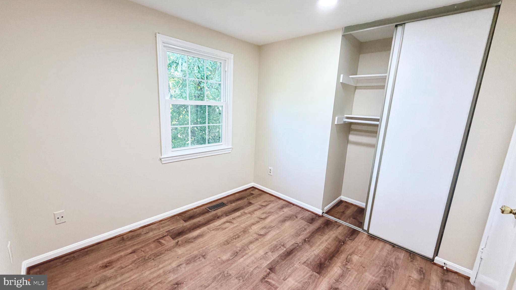 122 Sharpstead Lane Gaithersburg, MD 20878 - Photo 19 of 43 an empty room with wooden floor and a window