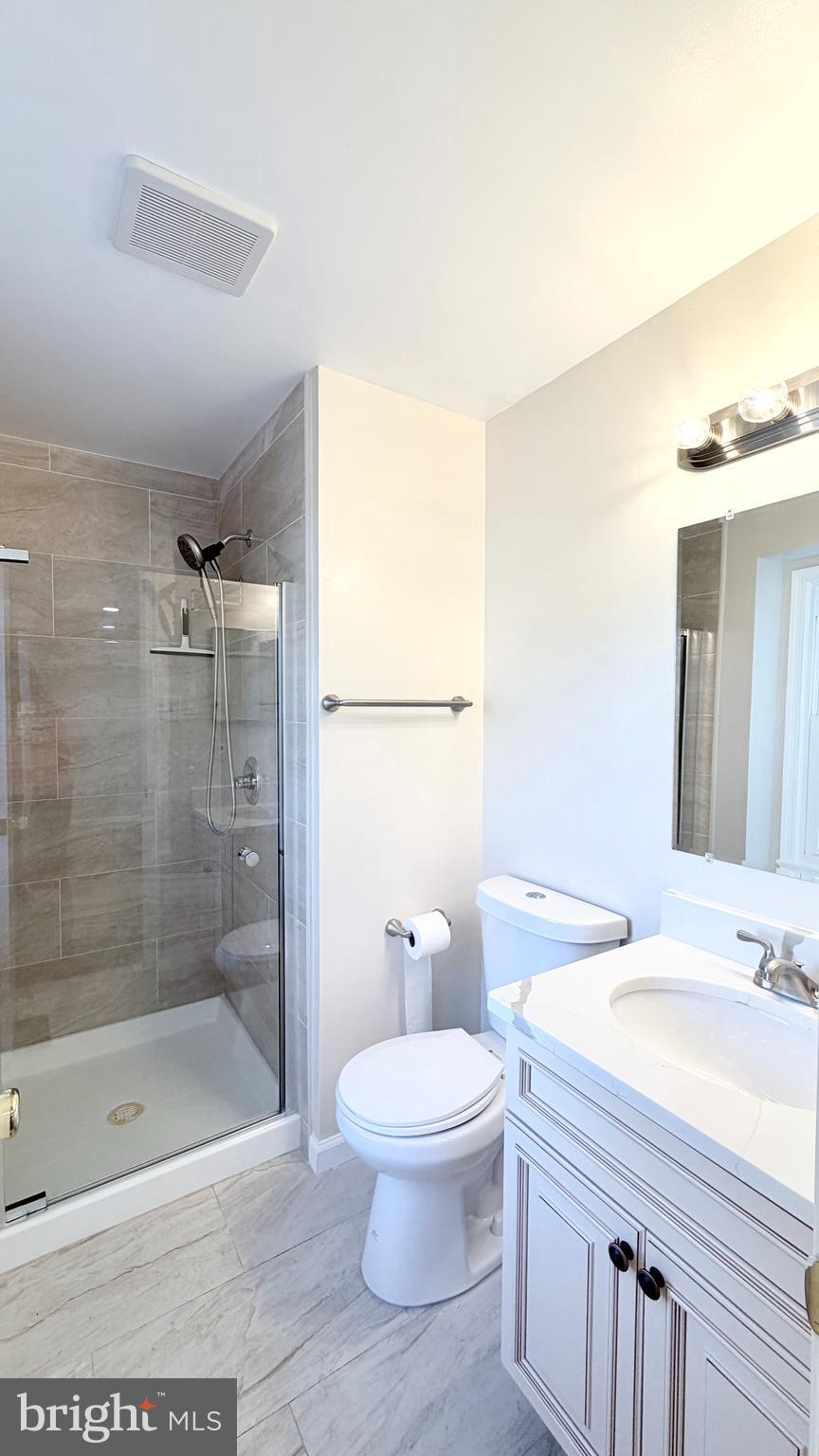 122 Sharpstead Lane Gaithersburg, MD 20878 - Photo 21 of 43 a bathroom with a granite countertop sink a toilet a mirror and shower