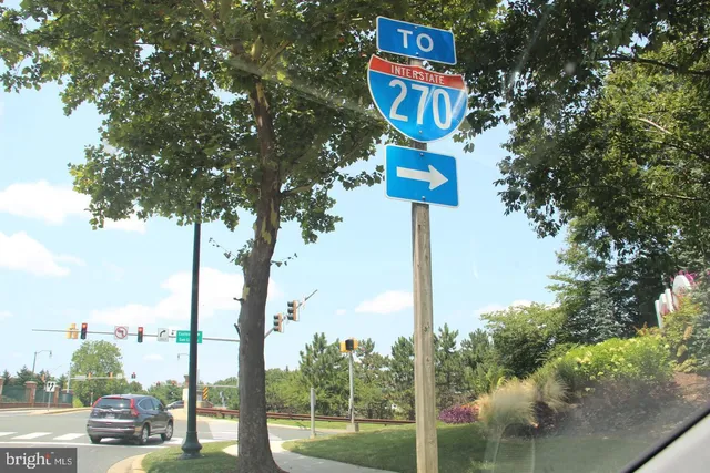 a street sign on a pole next to a road
