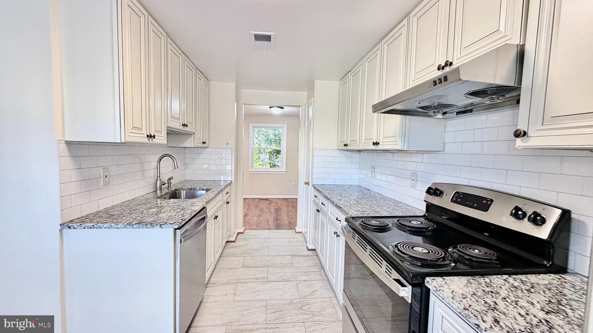 122 Sharpstead Lane Gaithersburg, MD 20878 - Photo 4 of 43 a kitchen with stainless steel appliances granite countertop a stove a sink dishwasher and cabinets with wooden floor