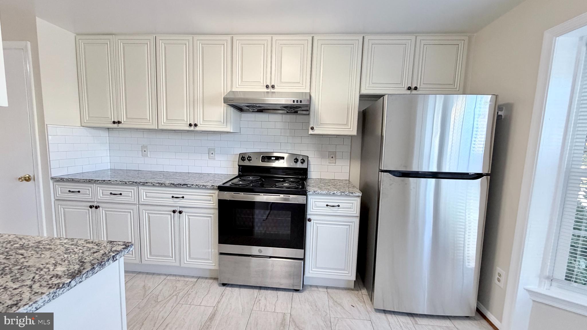 122 Sharpstead Lane Gaithersburg, MD 20878 - Photo 5 of 43 a kitchen with stainless steel appliances granite countertop a refrigerator sink and white cabinets