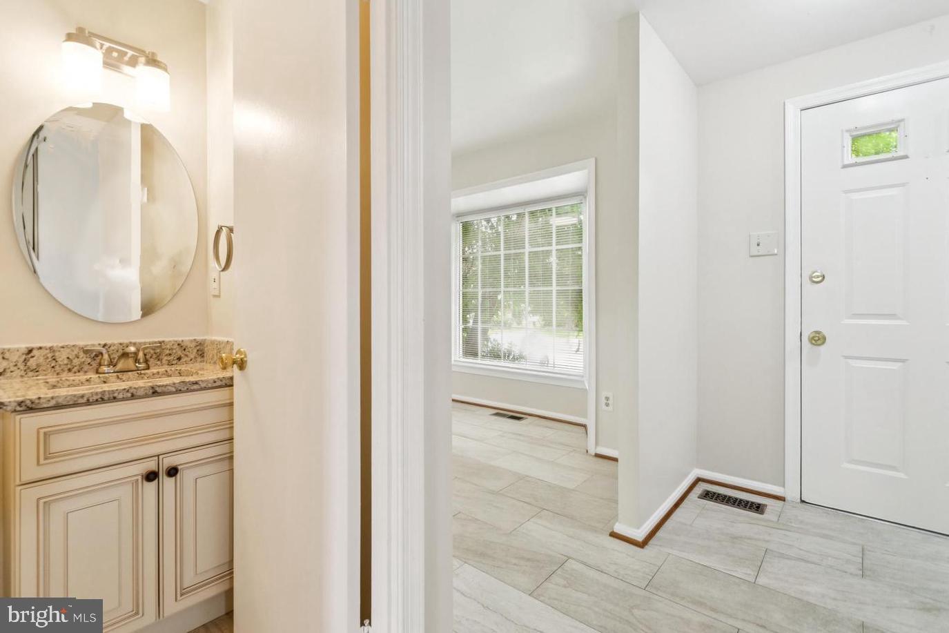 122 Sharpstead Lane Gaithersburg, MD 20878 - Photo 9 of 43 an entryway with wooden floor and mirror