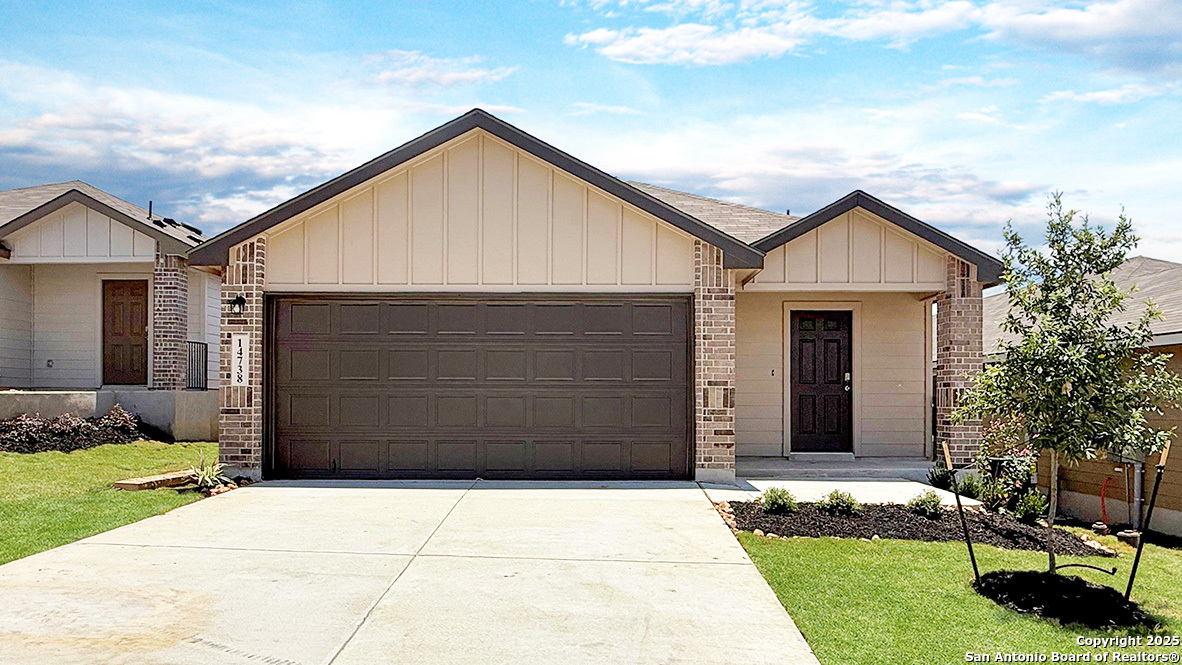 a front view of a house with a garden