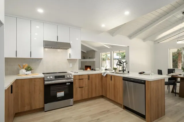 a kitchen with stainless steel appliances a sink stove and cabinets