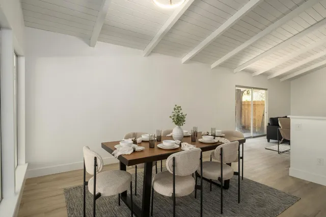 a view of a dining room with furniture and window