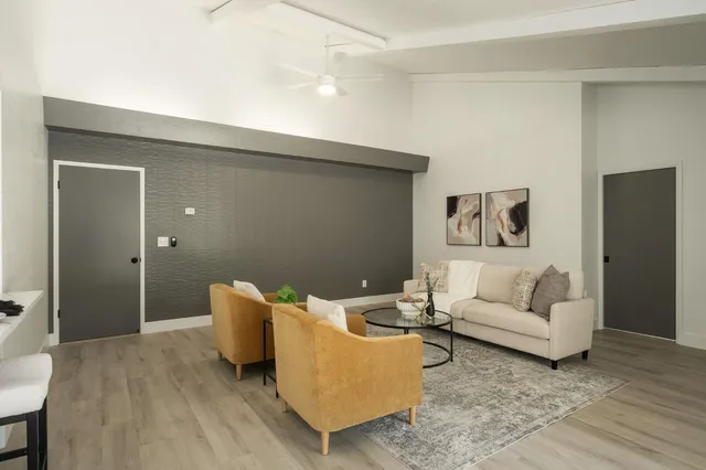 a living room with furniture and a wooden floor