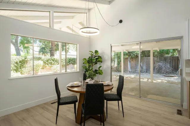 a dining room with furniture window and outside view