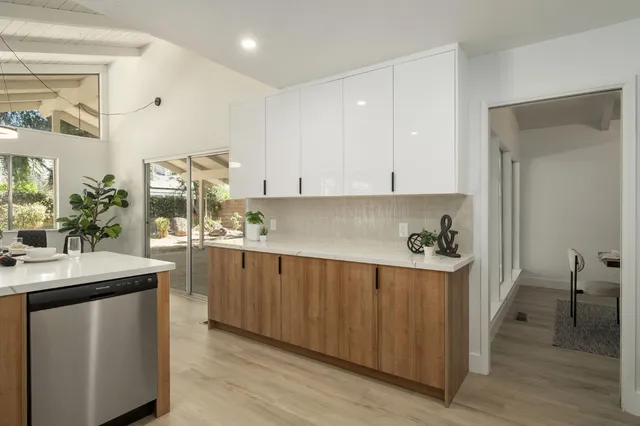 a kitchen with stainless steel appliances a sink stove and cabinets