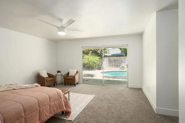 a bedroom with a bed and a large window