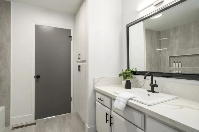 a bathroom with a sink and a mirror