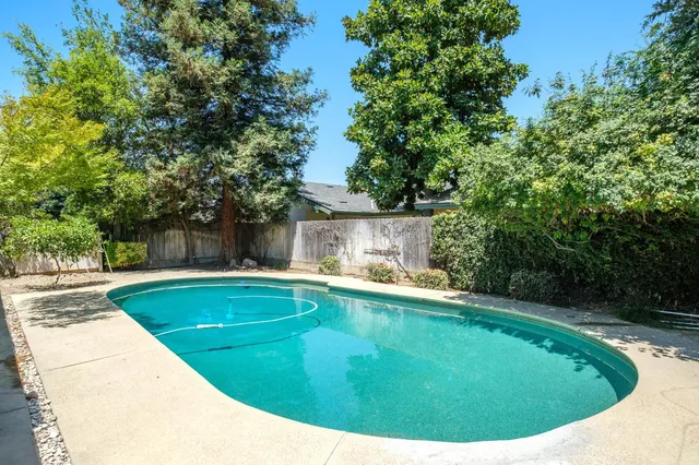 a view of a swimming pool with a yard
